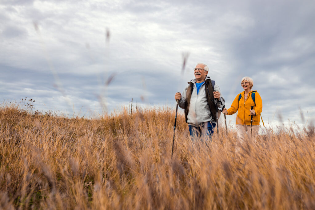 Active older couple enjoying a hike outdoors.