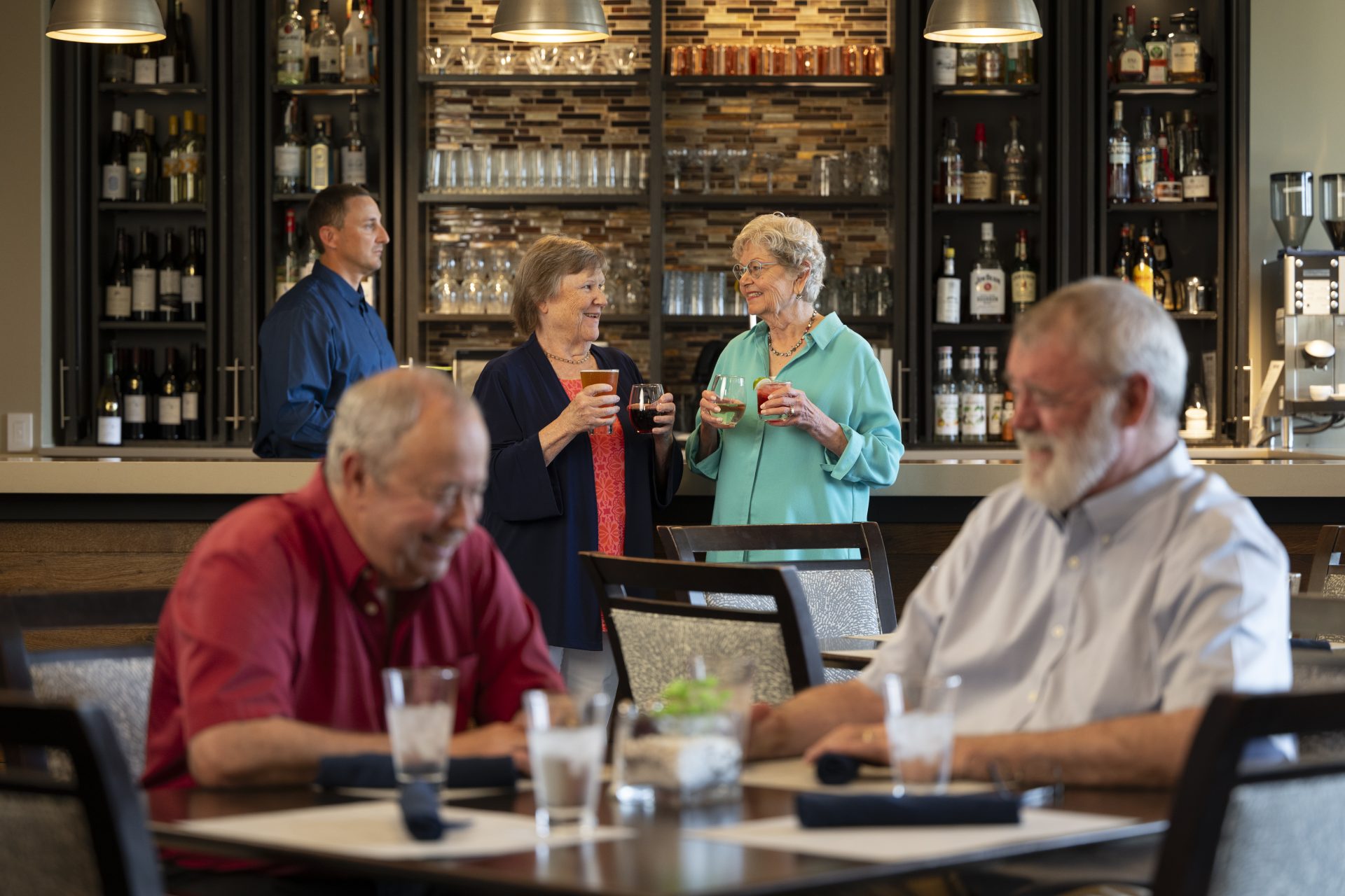 Group of residents enjoying drinks at the bar 